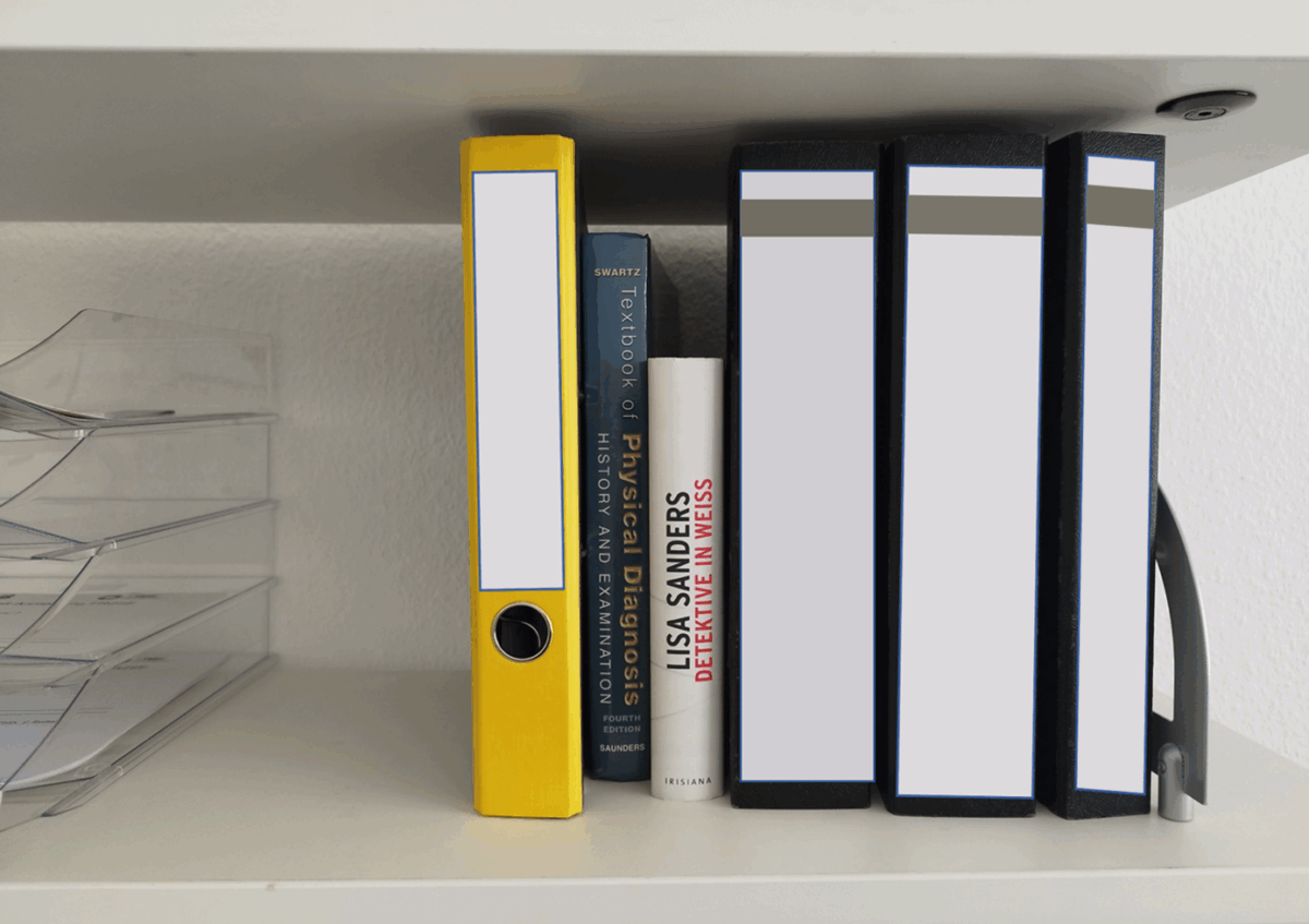 Figure 3:	Case board with books and binders. Anonymized. Medical center in Germany. Picture taken by author, April 3, 2024.